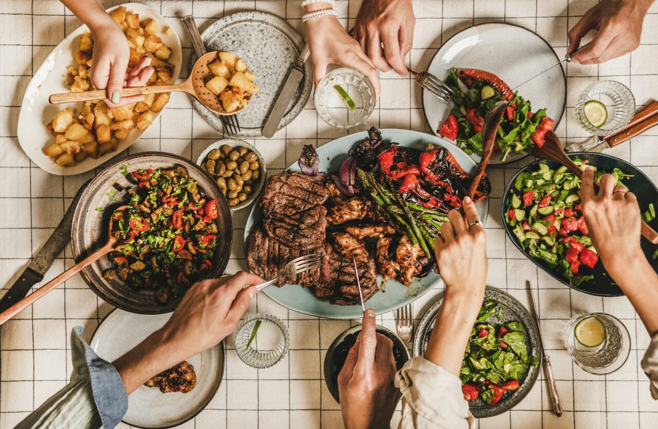 flat-lay-of-people-having-barbeque-party-with-meat-and-vegetables.jpg